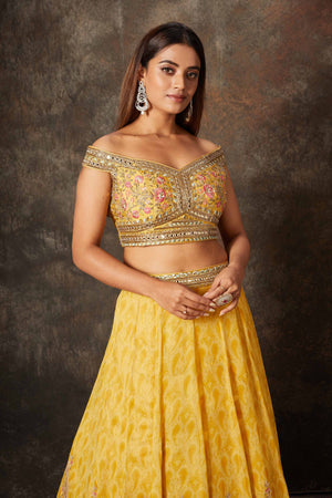 Buy mango yellow embroidered off-shoulder lehenga online in USA. Look stylish at parties and special occasions in beautiful designer sarees, embroidered sarees, handwoven silk, party sarees, lehengas, Anarkali suits from Pure Elegance Indian fashion store in USA.-closeup