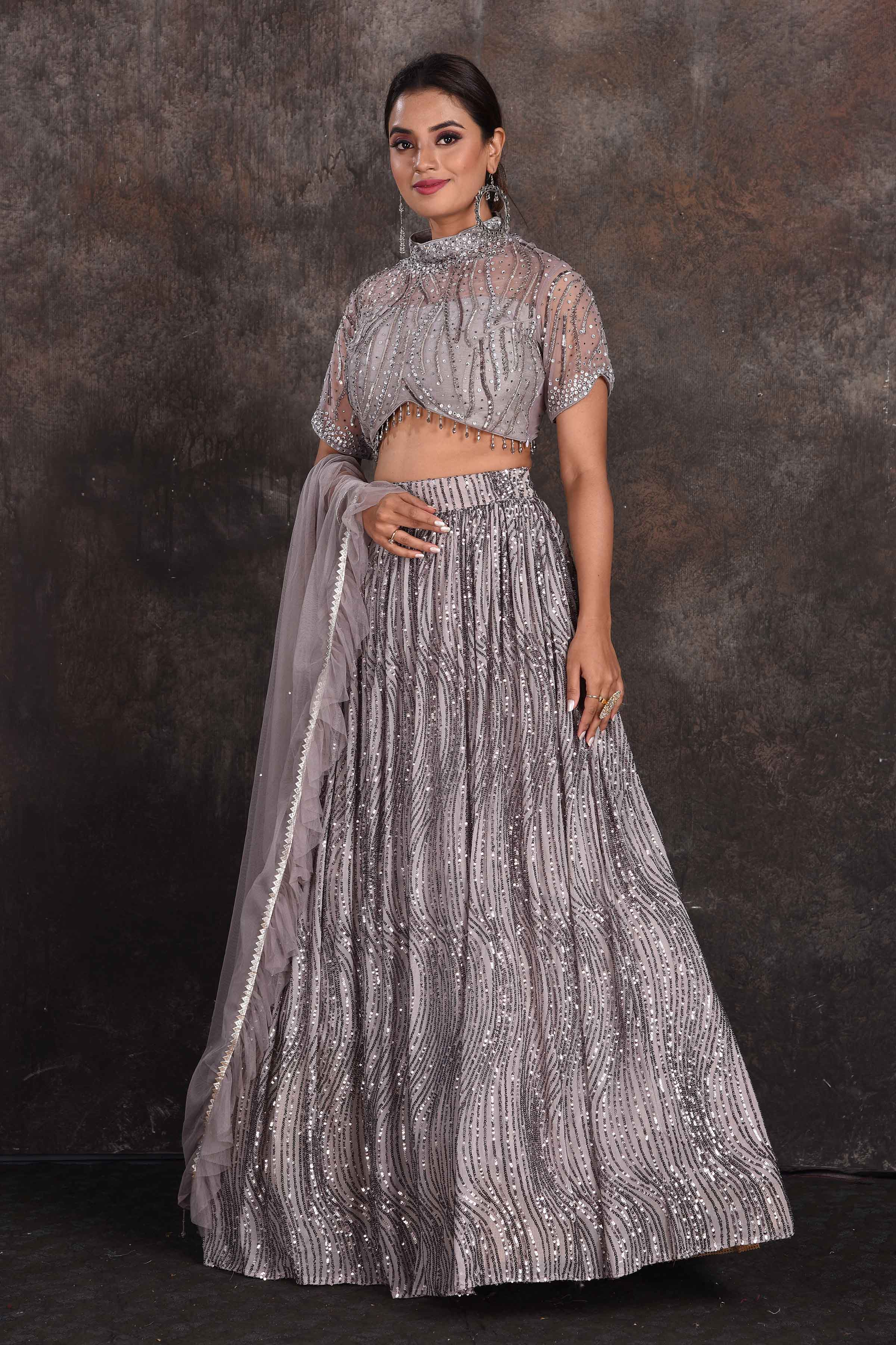 Shop stunning grey embellished designer lehenga online in USA with dupatta. Be the star of the occasion in this stylish designer lehengas, designer gowns, Indowestern dresses, Anarkali suits, sharara suits from Pure Elegance Indian fashion store in USA.-side