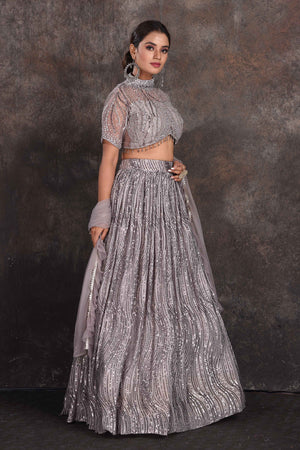 Shop stunning grey embellished designer lehenga online in USA with dupatta. Be the star of the occasion in this stylish designer lehengas, designer gowns, Indowestern dresses, Anarkali suits, sharara suits from Pure Elegance Indian fashion store in USA.-right
