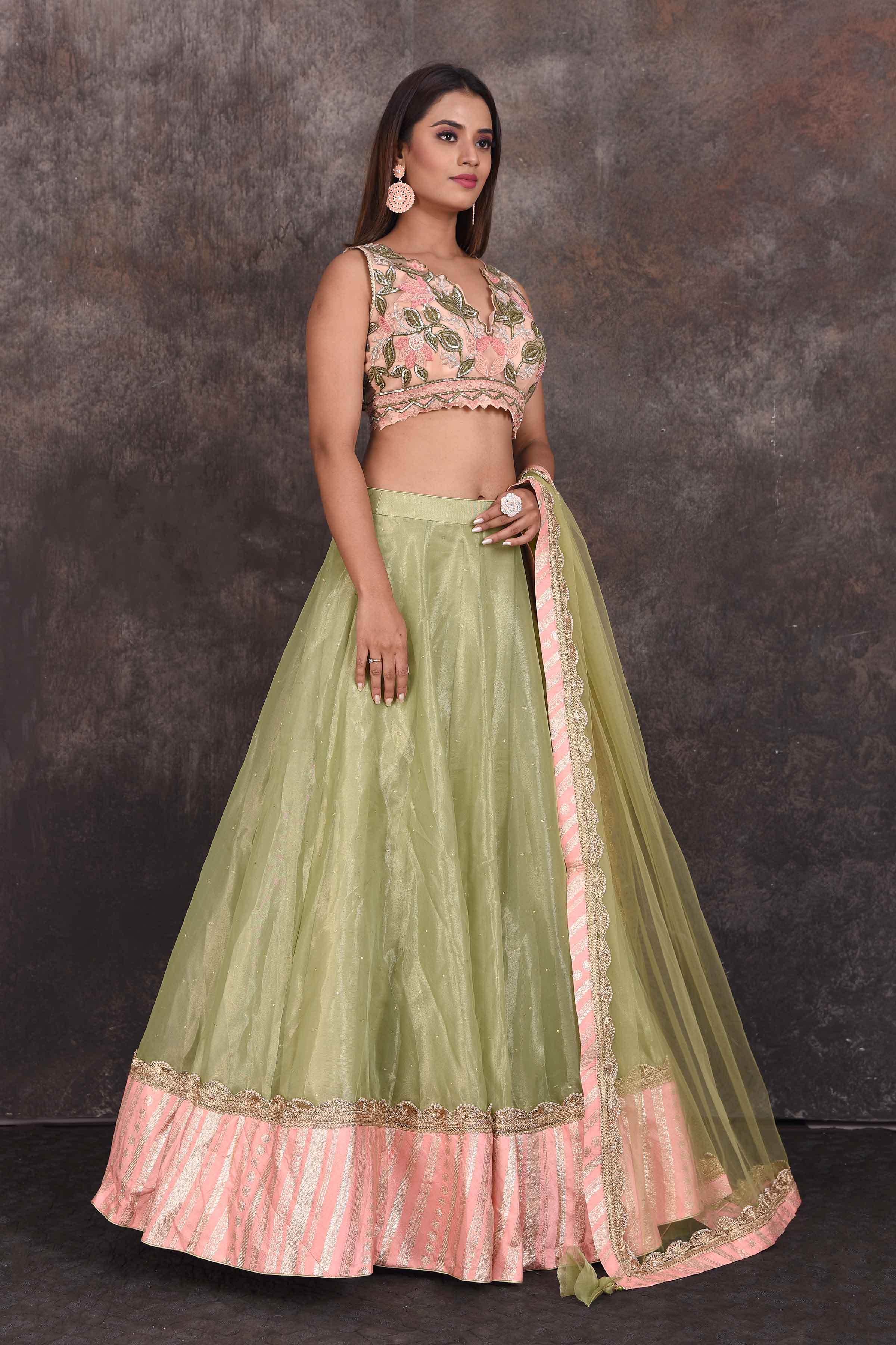 Shop beautiful pista green designer lehenga online in USA with pink blouse. Be the star of the occasion in this stylish designer lehengas, designer gowns, Indowestern dresses, Anarkali suits, sharara suits from Pure Elegance Indian fashion store in USA.-side