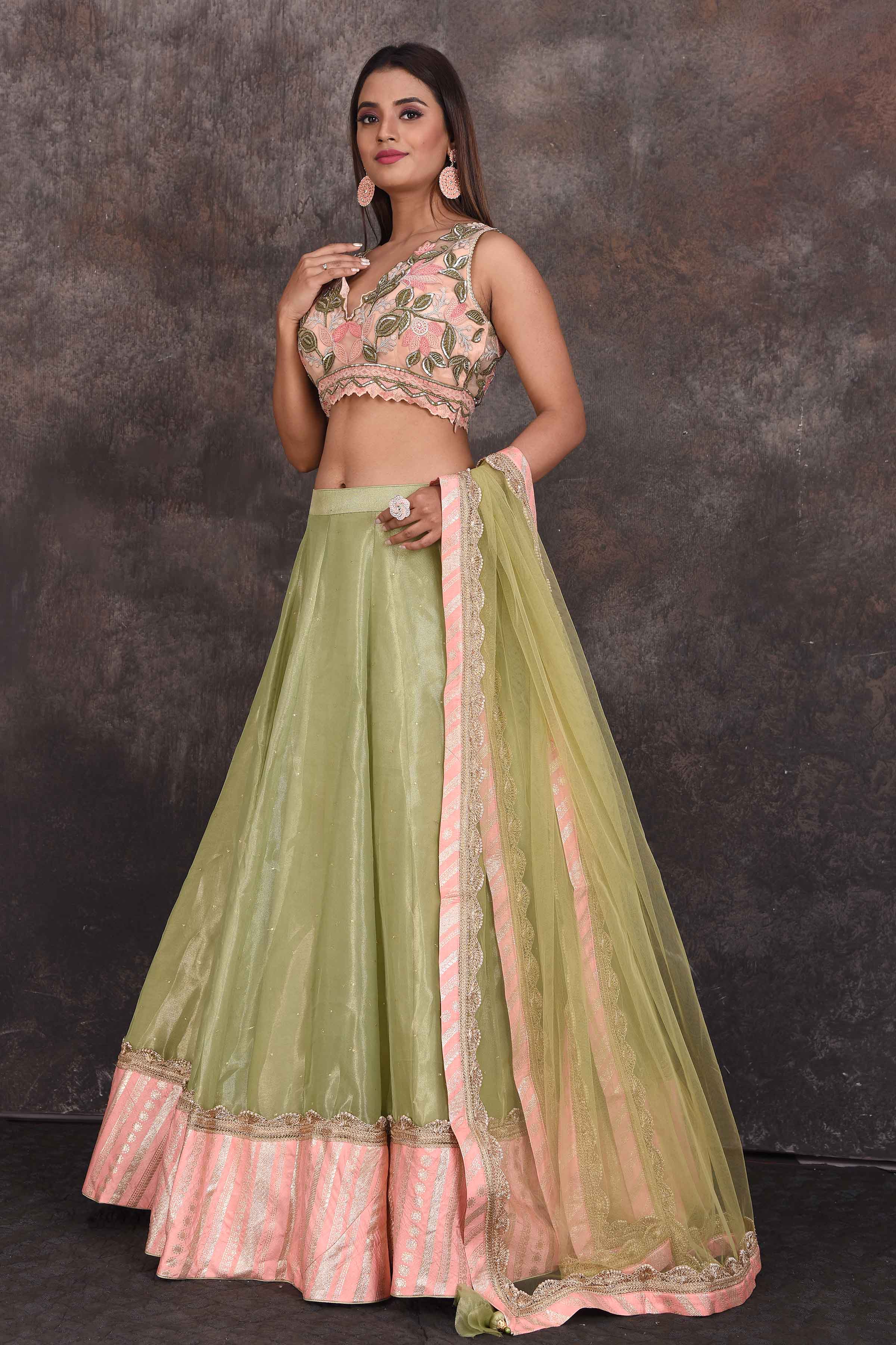 Shop beautiful pista green designer lehenga online in USA with pink blouse. Be the star of the occasion in this stylish designer lehengas, designer gowns, Indowestern dresses, Anarkali suits, sharara suits from Pure Elegance Indian fashion store in USA.-left