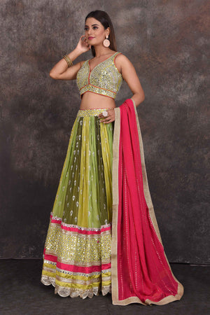 Buy beautiful green and yellow mirror work lehenga online in USA with pink dupatta. Be the star of the occasion in this stylish designer lehengas, designer gowns, Indowestern dresses, Anarkali suits, sharara suits from Pure Elegance Indian fashion store in USA.-side
