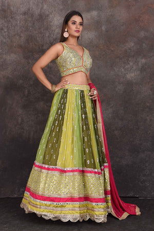 Buy beautiful green and yellow mirror work lehenga online in USA with pink dupatta. Be the star of the occasion in this stylish designer lehengas, designer gowns, Indowestern dresses, Anarkali suits, sharara suits from Pure Elegance Indian fashion store in USA.-right