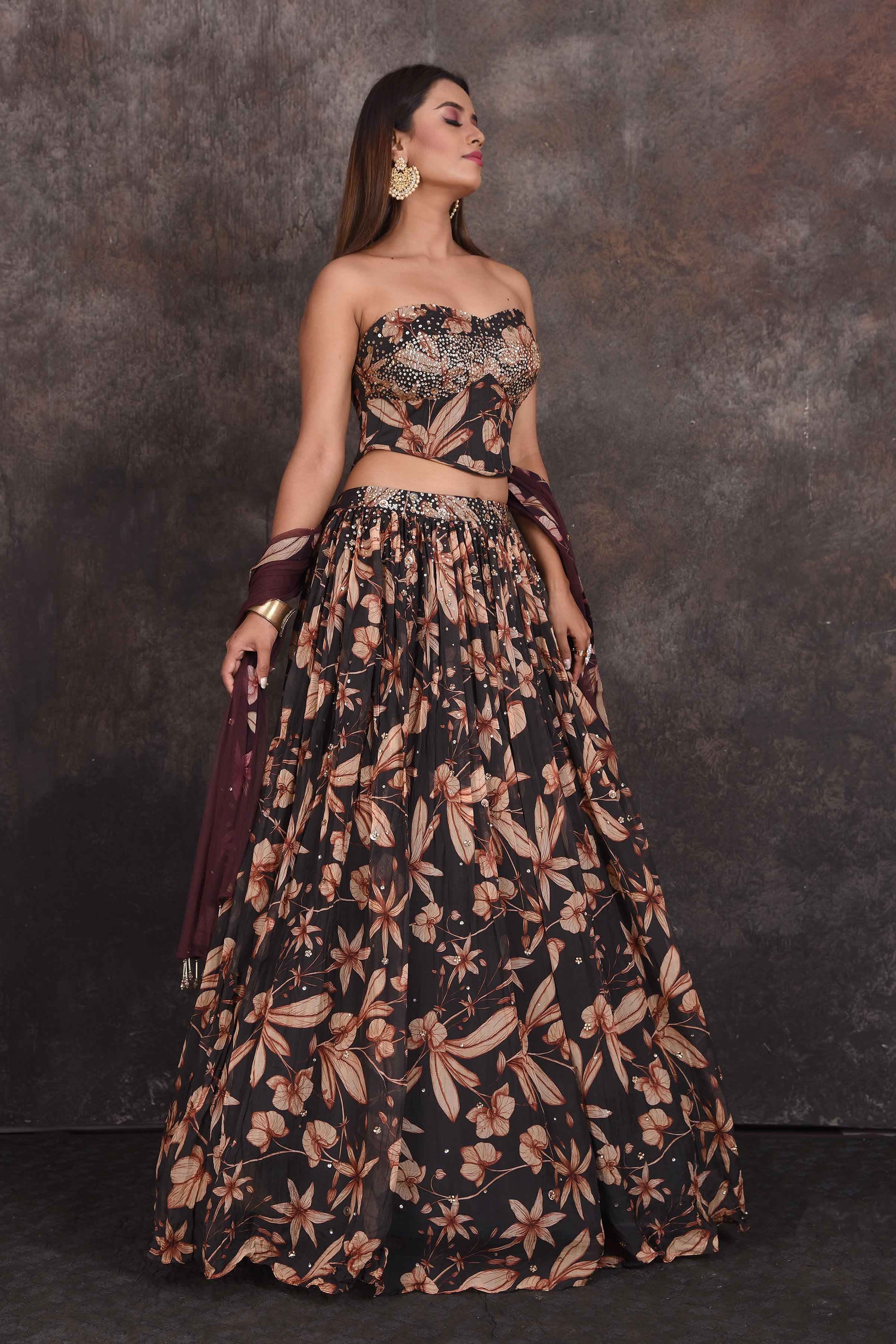 Buy stunning black floral designer lehenga online in USA with corset blouse. Be the star of the occasion in this stylish designer lehengas, designer gowns, Indowestern dresses, Anarkali suits, sharara suits from Pure Elegance Indian fashion store in USA.-right