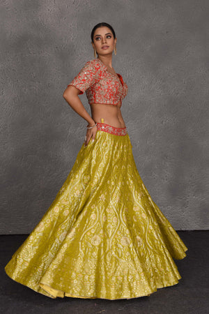 Buy yellow and red hand embroidered Banarasi lehenga online in USA with dupatta. Flaunt your Indian style on festive occasions in stunning designer lehengas, Anarkali suit, sharara suits, designer gowns, designer sarees, embroidered sarees from Pure Elegance India fashion store in USA. -side