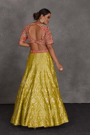 Buy yellow and red hand embroidered Banarasi lehenga online in USA with dupatta. Flaunt your Indian style on festive occasions in stunning designer lehengas, Anarkali suit, sharara suits, designer gowns, designer sarees, embroidered sarees from Pure Elegance India fashion store in USA. -back