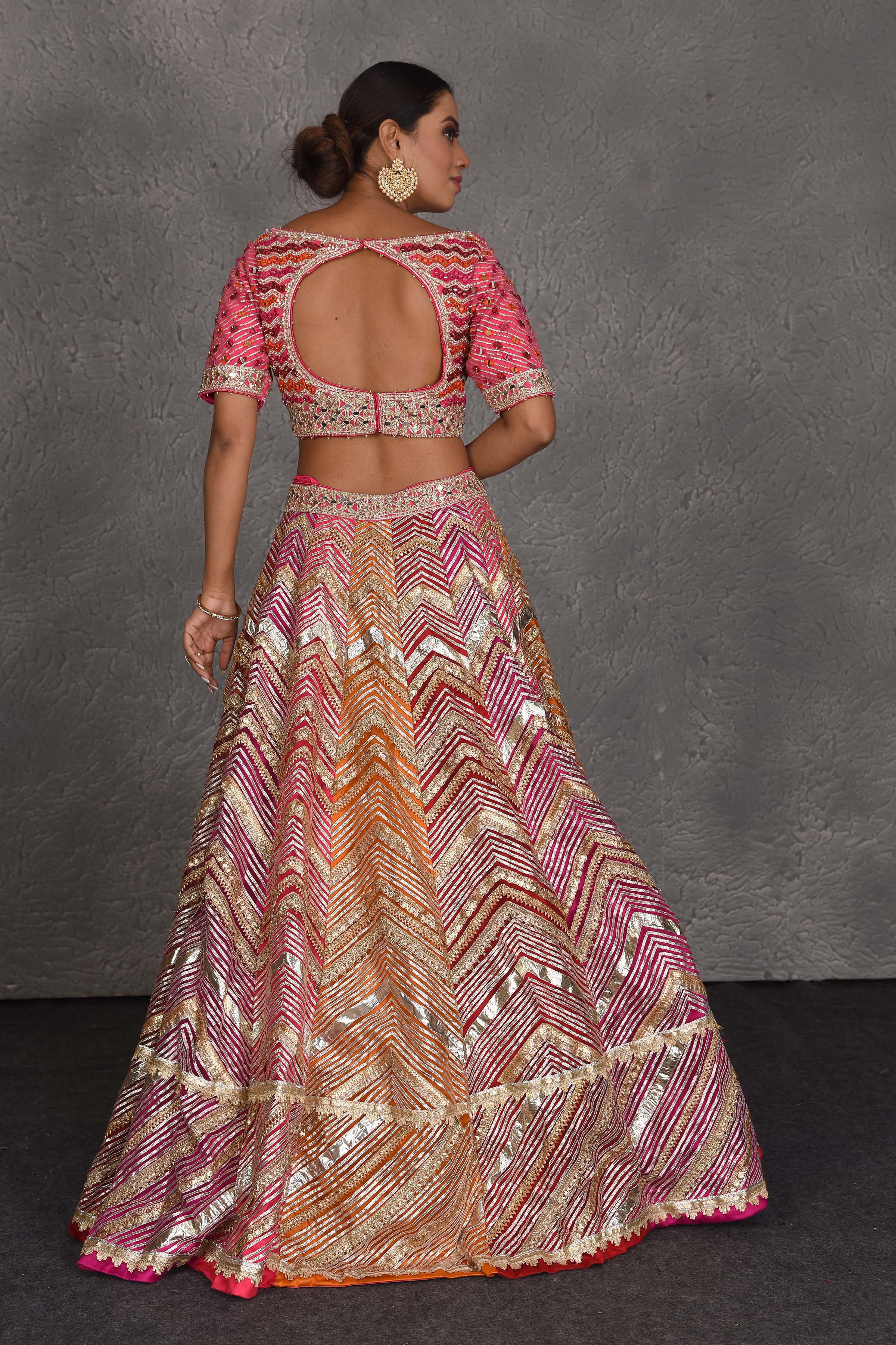 Buy stunning pink heavy gota lace work designer lehenga online in USA with dupatta. Flaunt your Indian style on festive occasions in stunning designer lehengas, Anarkali suit, sharara suits, designer gowns, designer sarees, embroidered sarees from Pure Elegance India fashion store in USA. -back