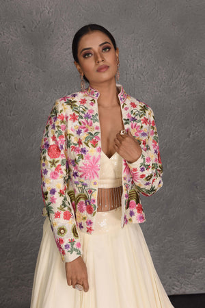 Shop beautiful cream skirt set online in USA with embroidered jacket. Flaunt your Indian style on festive occasions in stunning designer lehengas, Anarkali suit, sharara suits, designer gowns, designer sarees, embroidered sarees from Pure Elegance India fashion store in USA. -closeup