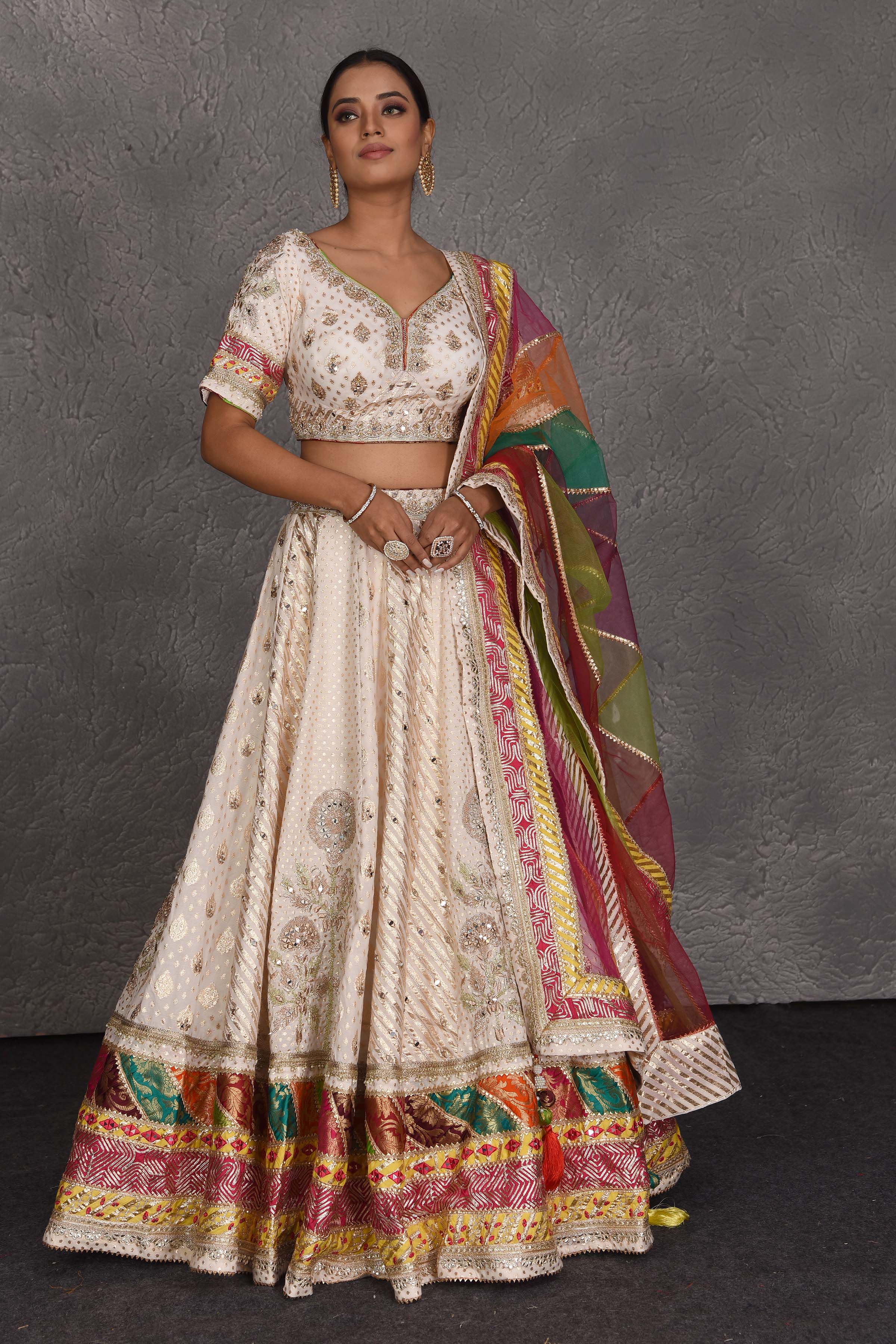 Buy cream embroidered lehenga online in USA with multicolor border. Flaunt your Indian style on festive occasions in stunning designer lehengas, Anarkali suit, sharara suits, designer gowns, designer sarees, embroidered sarees from Pure Elegance India fashion store in USA. -full view