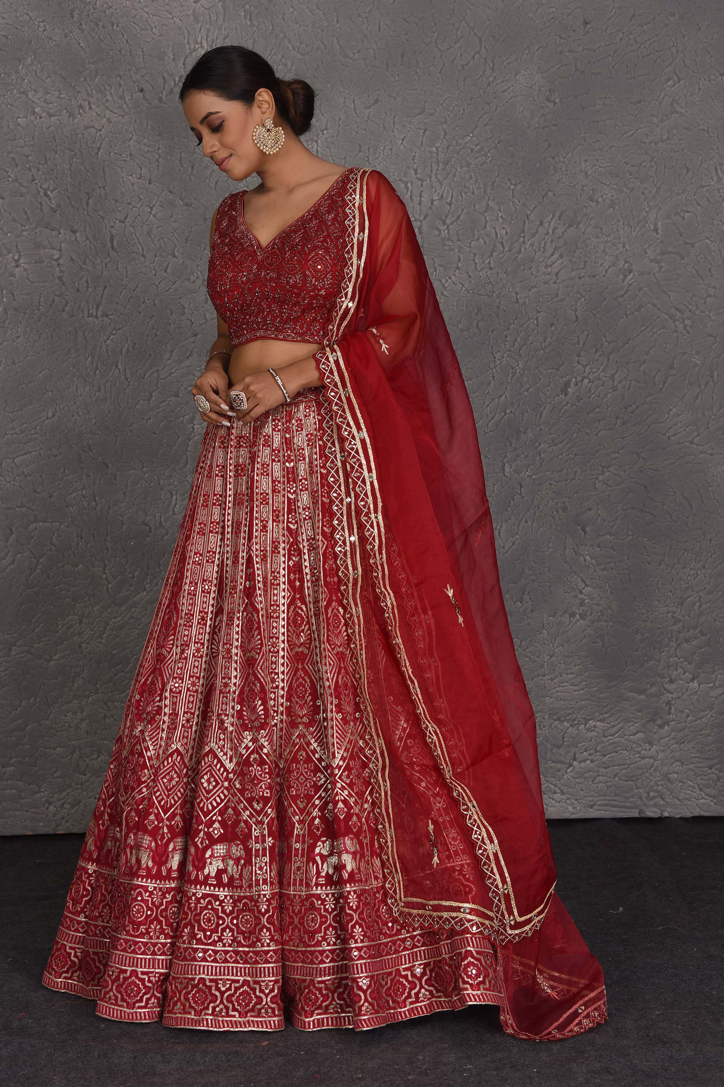 Shop red embroidered designer lehenga online in USA with net dupatta. Flaunt your Indian style on festive occasions in stunning designer lehengas, Anarkali suit, sharara suits, designer gowns, designer sarees, embroidered sarees from Pure Elegance India fashion store in USA. -side