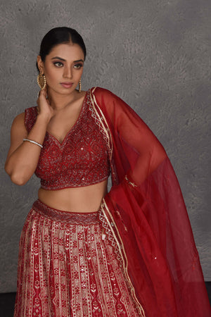 Shop red embroidered designer lehenga online in USA with net dupatta. Flaunt your Indian style on festive occasions in stunning designer lehengas, Anarkali suit, sharara suits, designer gowns, designer sarees, embroidered sarees from Pure Elegance India fashion store in USA. -closeup