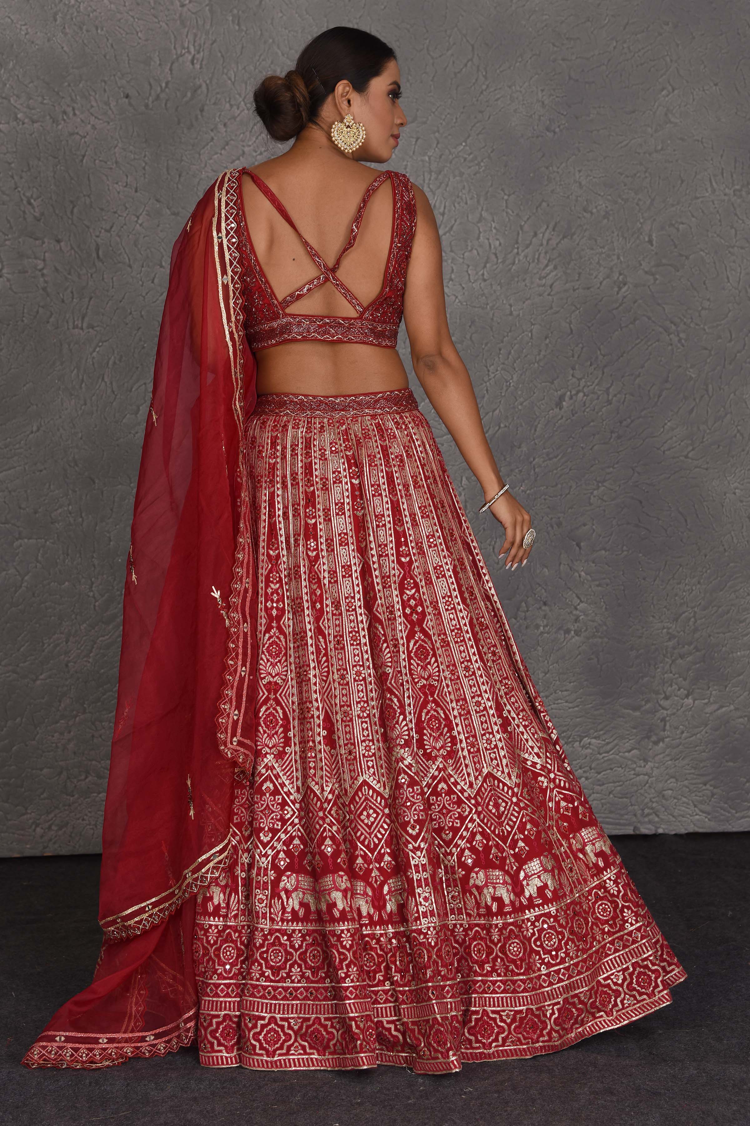 Shop red embroidered designer lehenga online in USA with net dupatta. Flaunt your Indian style on festive occasions in stunning designer lehengas, Anarkali suit, sharara suits, designer gowns, designer sarees, embroidered sarees from Pure Elegance India fashion store in USA. -back
