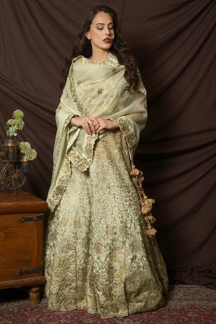 Buy gorgeous dusty green foil print embroidered lehenga online in USA with dupatta. Shine at weddings and special occasions with beautiful Indian designer dresses, gowns, lehengas from Pure Elegance Indian clothing store in USA.-front