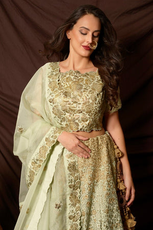 Buy gorgeous dusty green foil print embroidered lehenga online in USA with dupatta. Shine at weddings and special occasions with beautiful Indian designer dresses, gowns, lehengas from Pure Elegance Indian clothing store in USA.-closeup