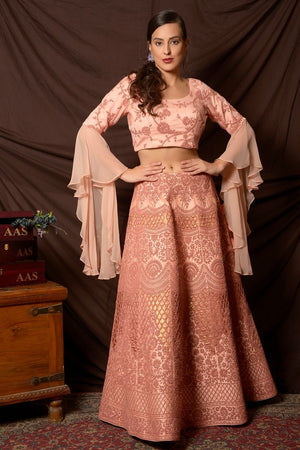 Shop lovely peach color embroidered silk lehenga online in USA with dupatta. Shine at weddings and special occasions with beautiful Indian designer dresses, gowns, lehengas from Pure Elegance Indian clothing store in USA.-front