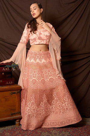Shop lovely peach color embroidered silk lehenga online in USA with dupatta. Shine at weddings and special occasions with beautiful Indian designer dresses, gowns, lehengas from Pure Elegance Indian clothing store in USA.-side