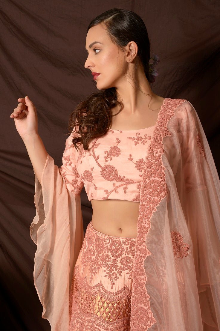 Shop lovely peach color embroidered silk lehenga online in USA with dupatta. Shine at weddings and special occasions with beautiful Indian designer dresses, gowns, lehengas from Pure Elegance Indian clothing store in USA.-closeup