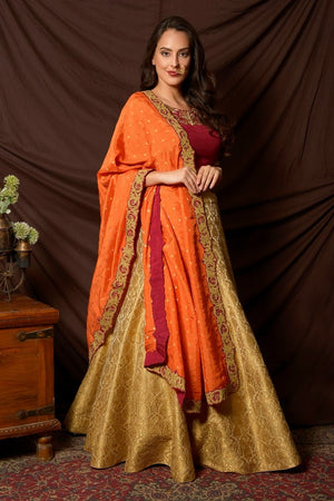 Buy gorgeous maroon and green embroidered brocade lehenga online in USA with orange dupatta. Shine at weddings and special occasions with beautiful Indian designer dresses, gowns, lehengas from Pure Elegance Indian clothing store in USA.-side