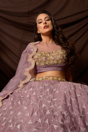 Buy attractive mauve color embroidered organza lehenga online in USA with dupatta. Shine at weddings and special occasions with beautiful Indian designer dresses, gowns, lehengas from Pure Elegance Indian clothing store in USA.-sitting