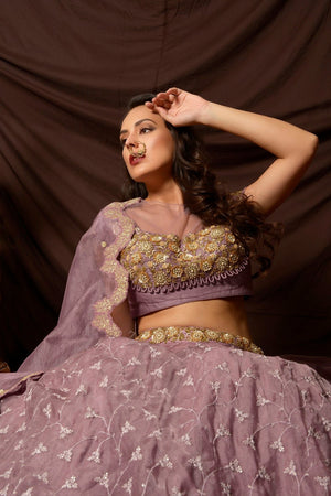 Buy attractive mauve color embroidered organza lehenga online in USA with dupatta. Shine at weddings and special occasions with beautiful Indian designer dresses, gowns, lehengas from Pure Elegance Indian clothing store in USA.-sitting side