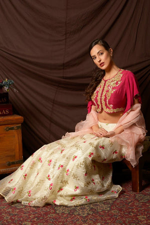 Shop gorgeous pink peplum cape embroidered organza lehenga online in USA. Shine at weddings and special occasions with beautiful Indian designer dresses, gowns, lehengas from Pure Elegance Indian clothing store in USA.-sitting