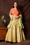 Shop gorgeous peach and gold embroidered brocade lehenga online in USA with pista green dupatta. Shine at weddings and special occasions with beautiful Indian designer dresses, gowns, lehengas from Pure Elegance Indian clothing store in USA.-full view