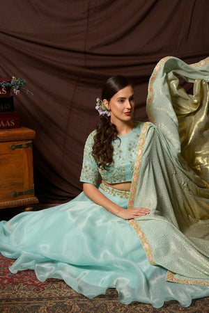 Buy beautiful light blue embroidered organza lehenga online in USA with sequin dupatta. Shine at weddings and special occasions with beautiful Indian designer dresses, gowns, lehengas from Pure Elegance Indian clothing store in USA.-full view