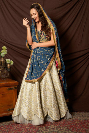 Shop beautiful blue and silver embroidered brocade lehenga online in USA with  dupatta. Shine at weddings and special occasions with beautiful Indian designer dresses, gowns, lehengas from Pure Elegance Indian clothing store in USA.-side