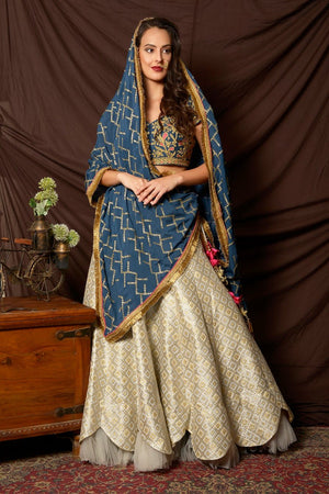 Shop beautiful blue and silver embroidered brocade lehenga online in USA with  dupatta. Shine at weddings and special occasions with beautiful Indian designer dresses, gowns, lehengas from Pure Elegance Indian clothing store in USA.-front