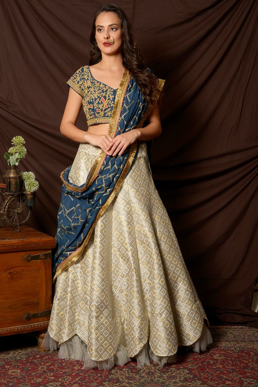 Shop beautiful blue and silver embroidered brocade lehenga online in USA with  dupatta. Shine at weddings and special occasions with beautiful Indian designer dresses, gowns, lehengas from Pure Elegance Indian clothing store in USA.-lehenga