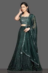 Shop stunning dark green mirror work lehenga online in USA with net dupatta. Dazzle on weddings and special occasions with exquisite Indian designer dresses, sharara suits, Anarkali suits, bridal lehegas from Pure Elegance Indian fashion store in USA.-full view