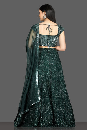 Shop stunning dark green mirror work lehenga online in USA with net dupatta. Dazzle on weddings and special occasions with exquisite Indian designer dresses, sharara suits, Anarkali suits, bridal lehegas from Pure Elegance Indian fashion store in USA.-back