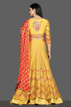 Buy gorgeous yellow embroidered lehenga online in USA with red and orange dupatta. Dazzle on weddings and special occasions with exquisite Indian designer dresses, sharara suits, Anarkali suits, bridal lehegas from Pure Elegance Indian fashion store in USA.-back