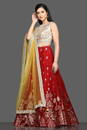 Buy beautiful cream and red embroidered lehenga online in USA with yellow dupatta. Dazzle on weddings and special occasions with exquisite Indian designer dresses, sharara suits, Anarkali suits, bridal lehegas from Pure Elegance Indian fashion store in USA.-left