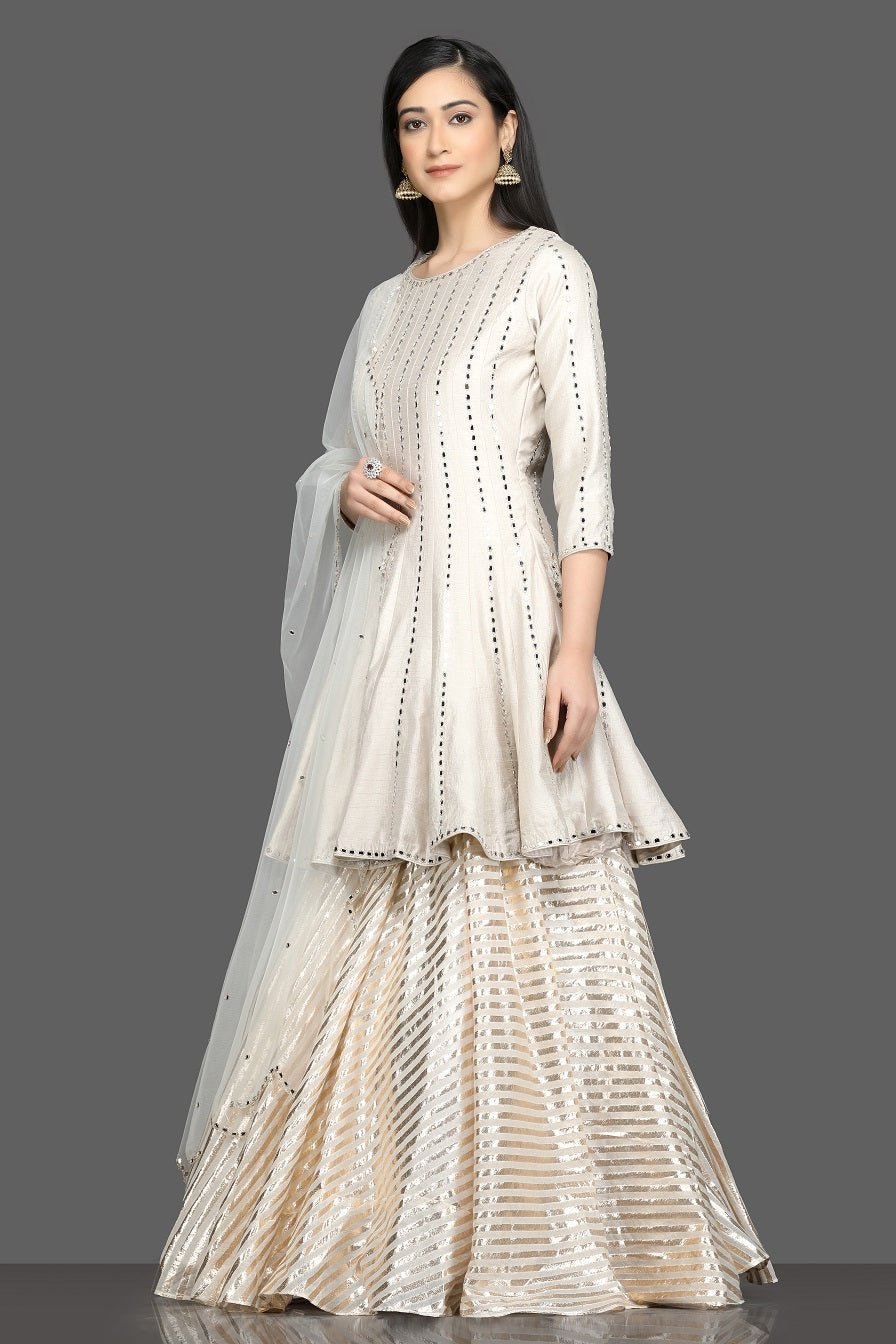 Shop beautiful white mirror work peplum lehenga online in USA with net dupatta. Dazzle on weddings and special occasions with exquisite Indian designer dresses, sharara suits, Anarkali suits, bridal lehegas from Pure Elegance Indian fashion store in USA.-right