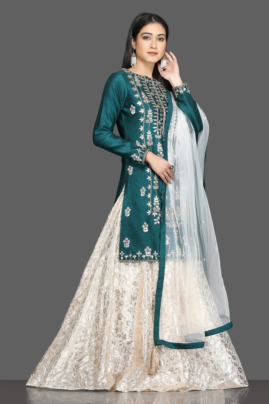 Buy stunning green and white embroidered lehenga online in USA with net dupatta. Dazzle on weddings and special occasions with exquisite Indian designer dresses, sharara suits, Anarkali suits, bridal lehengas from Pure Elegance Indian fashion store in USA.-side