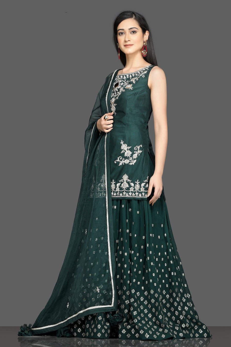 Buy stunning dark green embroidered lehenga online in USA with matching dupatta. Dazzle on weddings and special occasions with exquisite Indian designer dresses, sharara suits, Anarkali suits, wedding lehengas from Pure Elegance Indian fashion store in USA.-left