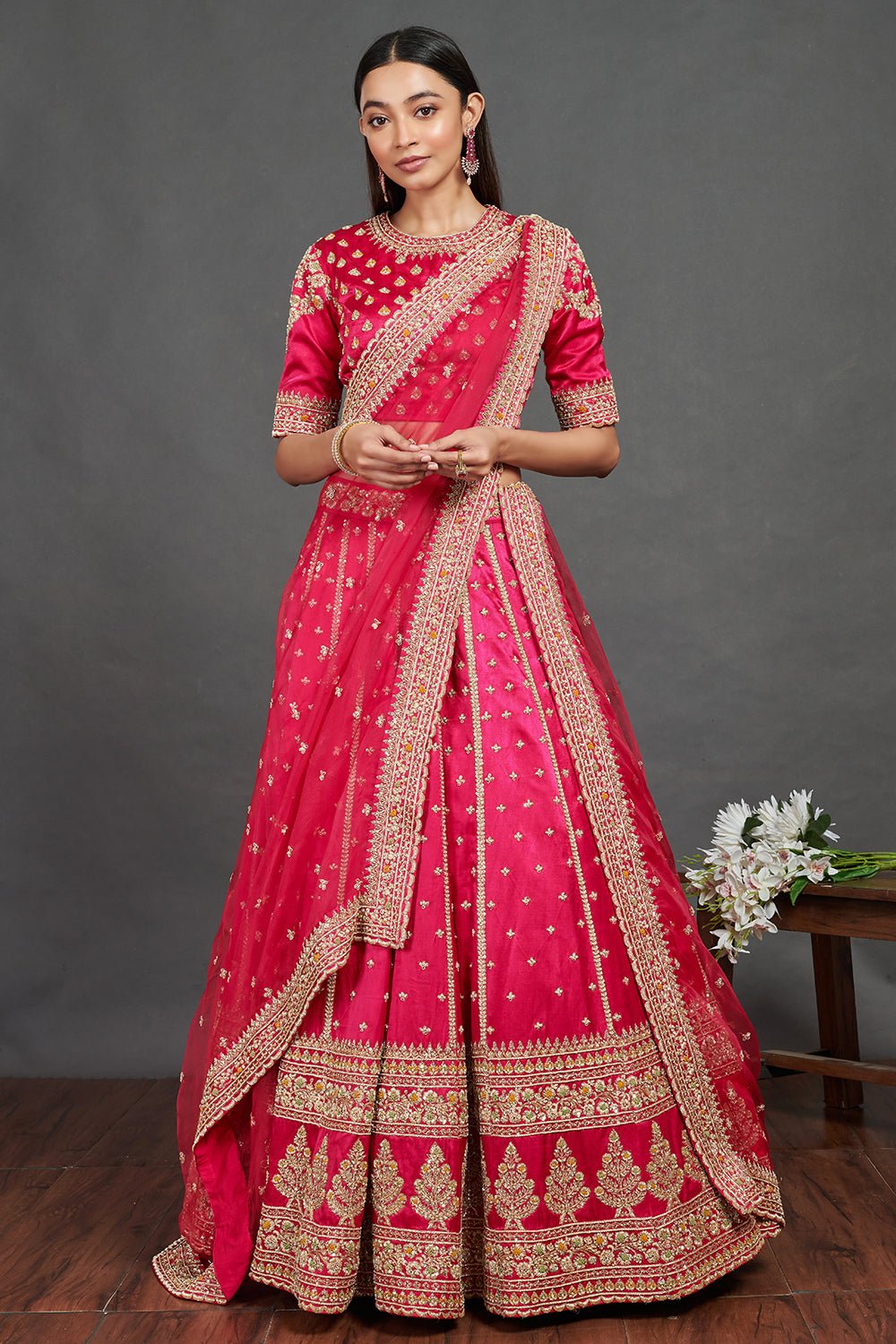 Shop gorgeous pink embroidered designer lehenga online in USA. Dazzle on weddings and special occasions with exquisite Indian designer dresses, sharara suits, Anarkali suits, wedding lehengas from Pure Elegance Indian fashion store in USA.-front