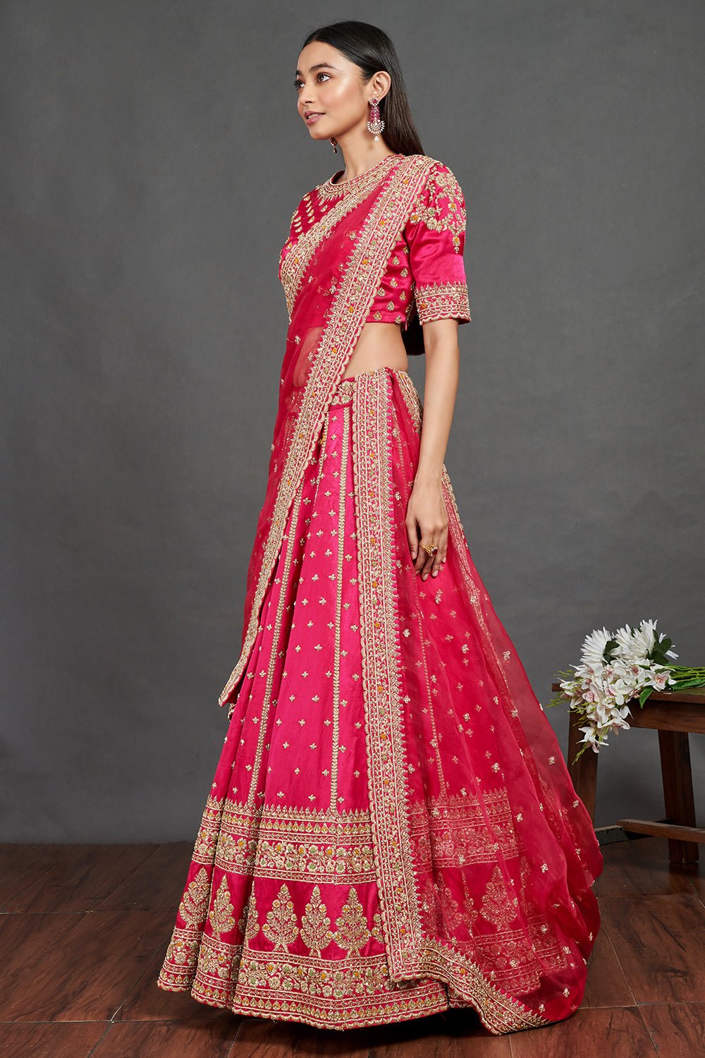 Shop gorgeous pink embroidered designer lehenga online in USA. Dazzle on weddings and special occasions with exquisite Indian designer dresses, sharara suits, Anarkali suits, wedding lehengas from Pure Elegance Indian fashion store in USA.-side