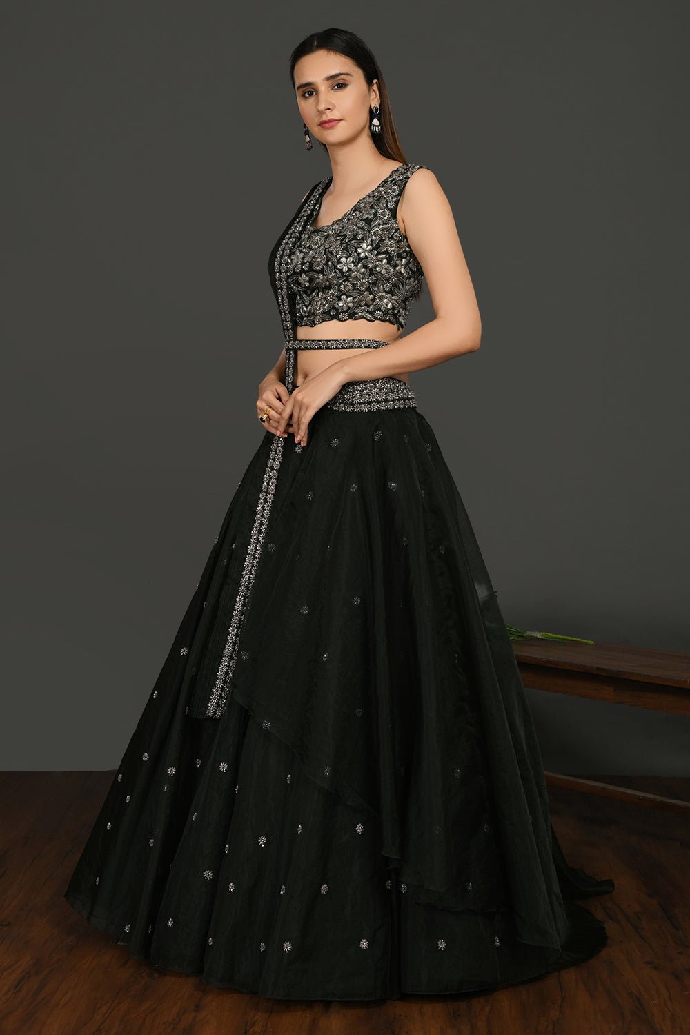 Buy stunning black embroidered designer lehenga online in USA with dupatta. Dazzle on weddings and special occasions with exquisite Indian designer dresses, sharara suits, Anarkali suits, wedding lehengas from Pure Elegance Indian fashion store in USA.-side