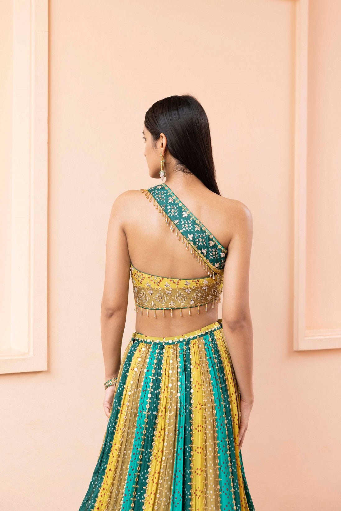 Shop beautiful green and mustard sripes bandhej one shoulder lehenga online in USA with dupatta. Dazzle on weddings and special occasions with exquisite Indian designer dresses, sharara suits, Anarkali suits, wedding lehengas from Pure Elegance Indian fashion store in USA.-back