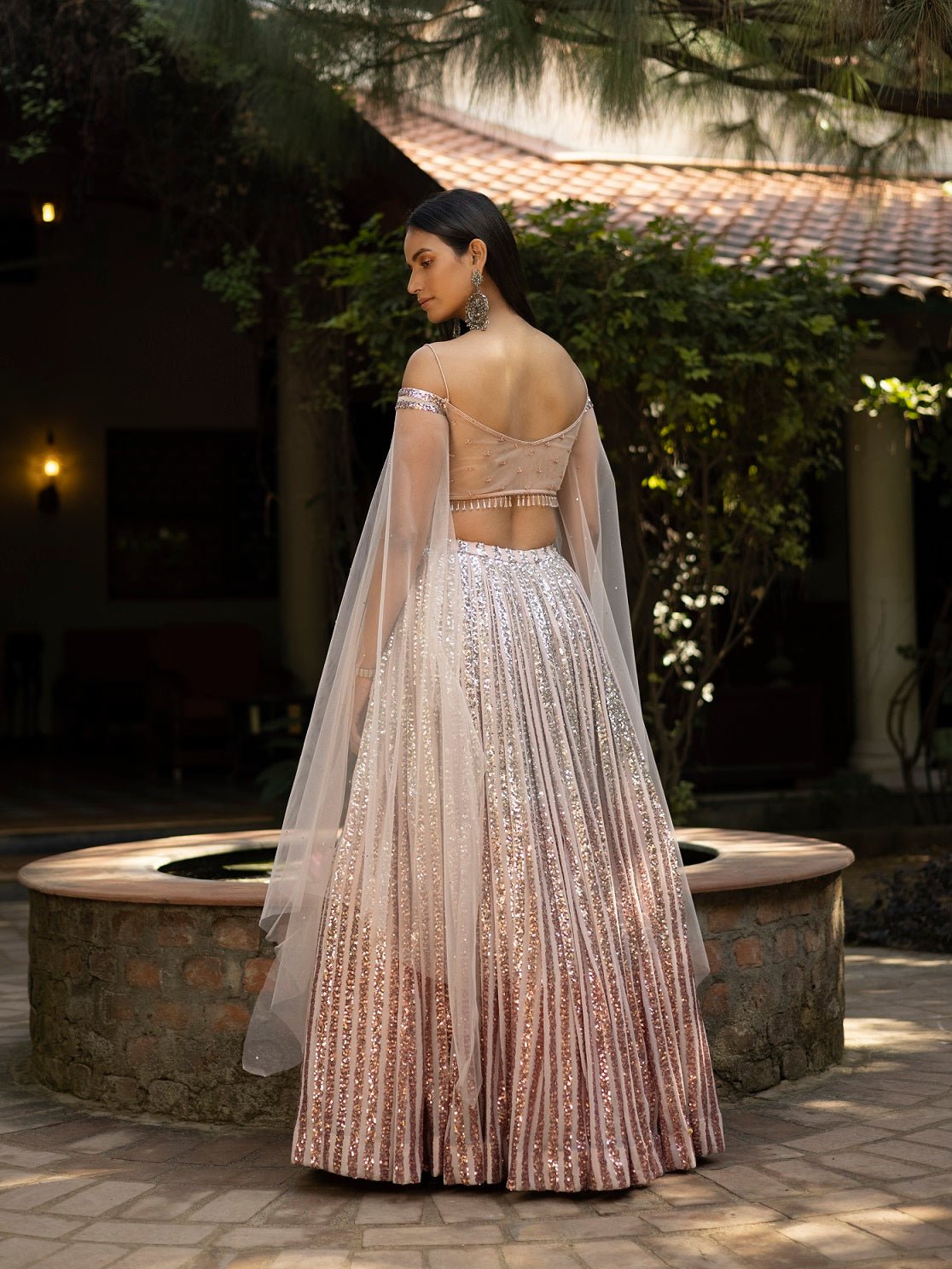 Buy stunning ombre peach shimmer designer lehenga online in USA with dupatta. Dazzle on weddings and special occasions with exquisite Indian designer dresses, sharara suits, Anarkali suits, wedding lehengas from Pure Elegance Indian fashion store in USA.-back