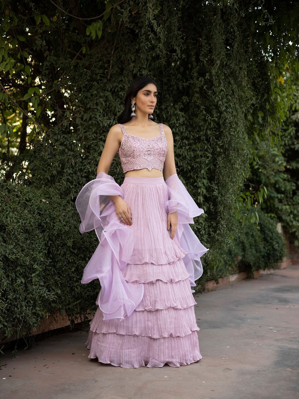 Buy stunning lavender layered designer lehenga online in USA with dupatta. Dazzle on weddings and special occasions with exquisite Indian designer dresses, sharara suits, Anarkali suits, wedding lehengas from Pure Elegance Indian fashion store in USA.-front