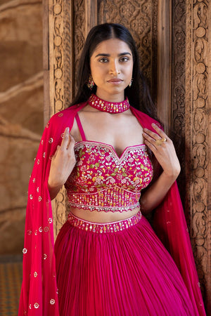 Buy beautiful rani pink embroidered lehenga online in USA with dupatta. Dazzle on weddings and special occasions with exquisite Indian designer dresses, sharara suits, Anarkali suits, bridal lehengas, sharara suits from Pure Elegance Indian clothing store in USA.-closeup
