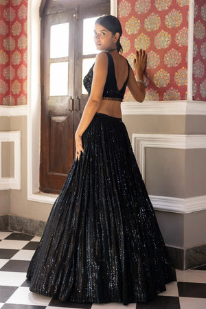 Buy black sequin embroidery lehenga online in USA with velvet blouse and dupatta. Dazzle on weddings and special occasions with exquisite Indian designer dresses, sharara suits, Anarkali suits, bridal lehengas, sharara suits from Pure Elegance Indian clothing store in USA.-back