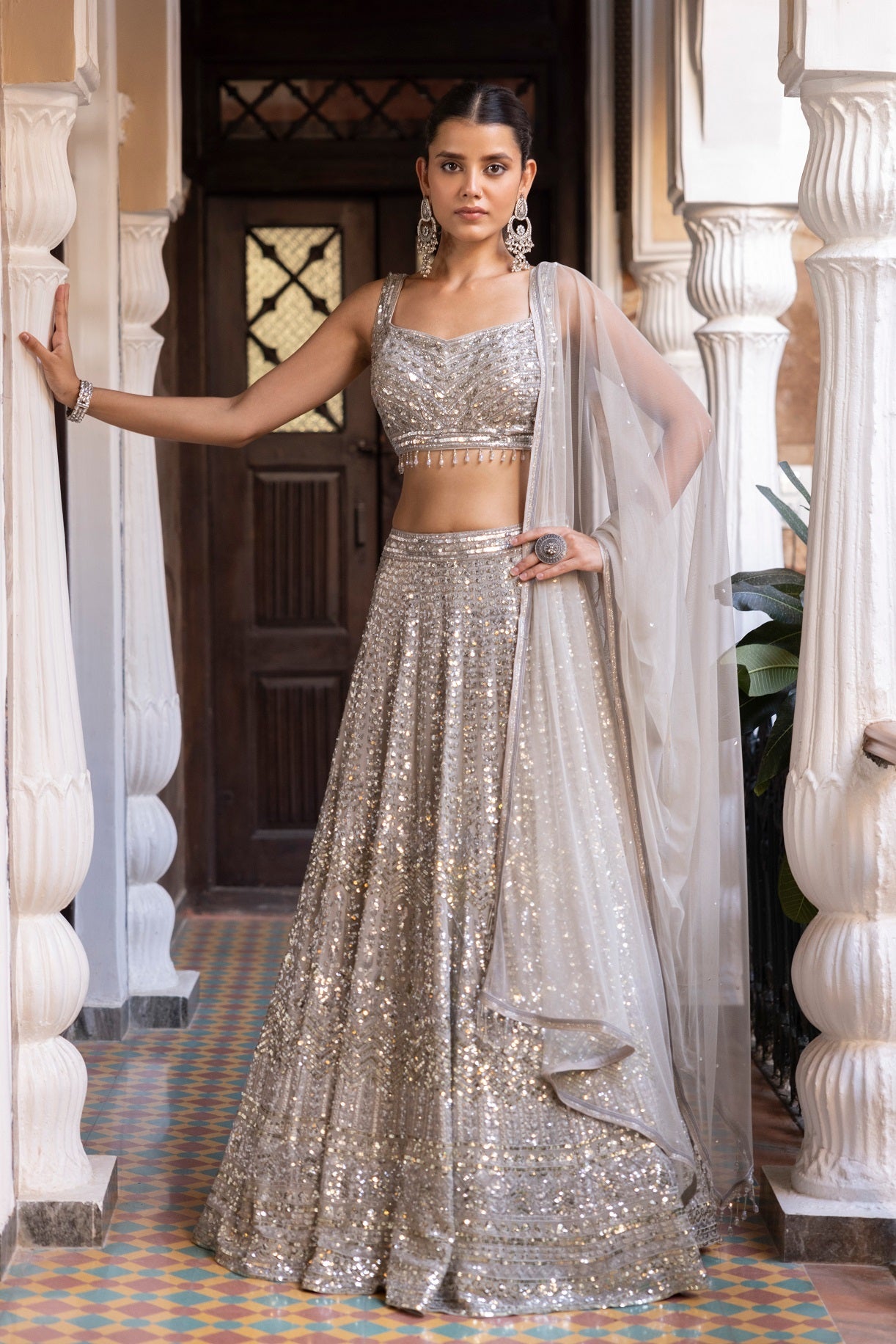 Shop beautiful ivory sequin embroidery lehenga online in USA with dupatta. Dazzle on weddings and special occasions with exquisite Indian designer dresses, sharara suits, Anarkali suits, bridal lehengas, sharara suits from Pure Elegance Indian clothing store in USA.-front