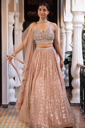 Shop beautiful rose gold mirror work georgette lehenga online in USA with dupatta. Dazzle on weddings and special occasions with exquisite Indian designer dresses, sharara suits, Anarkali suits, bridal lehengas, sharara suits from Pure Elegance Indian clothing store in USA.-lehenga