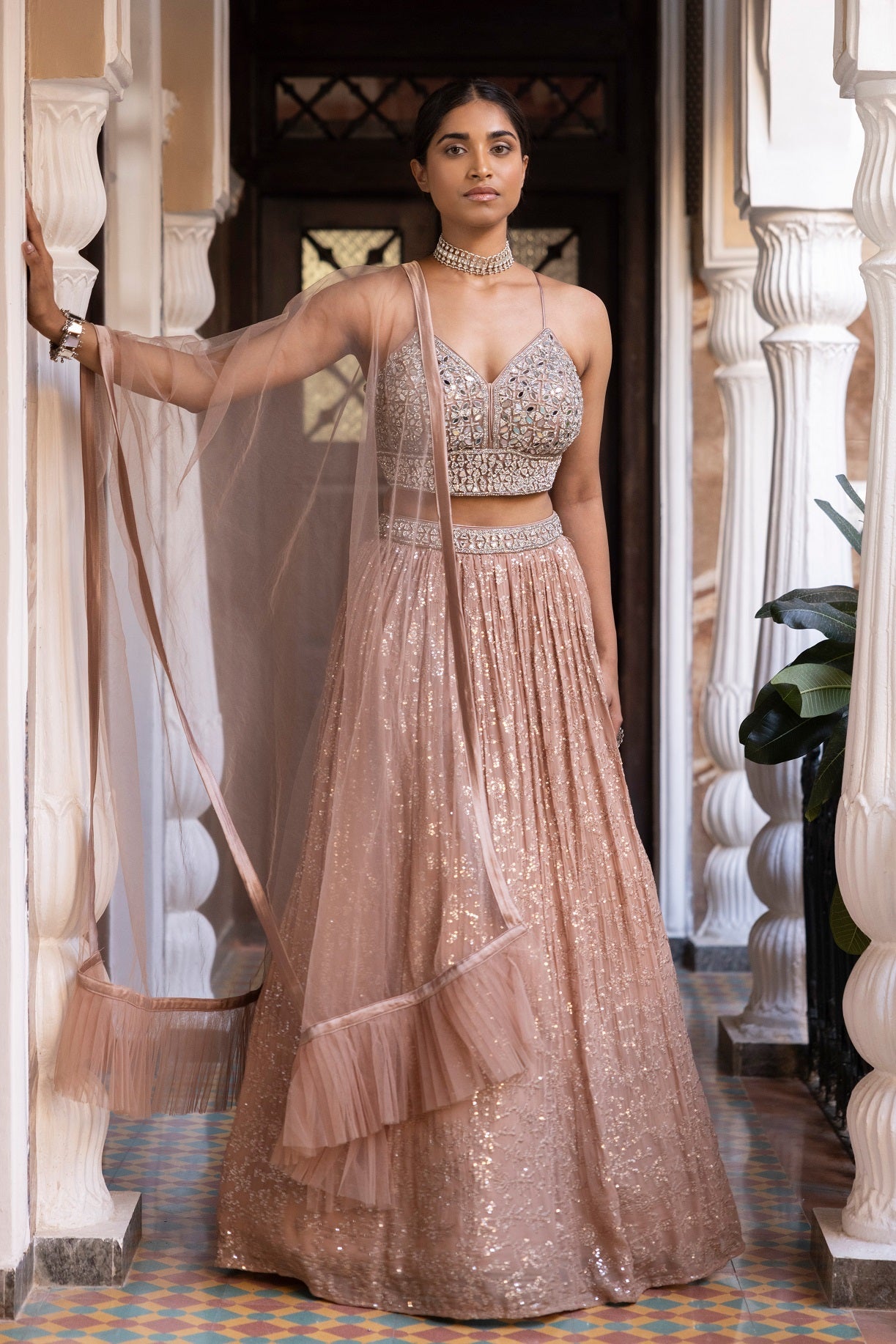 Shop beautiful rose gold mirror work georgette lehenga online in USA with dupatta. Dazzle on weddings and special occasions with exquisite Indian designer dresses, sharara suits, Anarkali suits, bridal lehengas, sharara suits from Pure Elegance Indian clothing store in USA.-full view