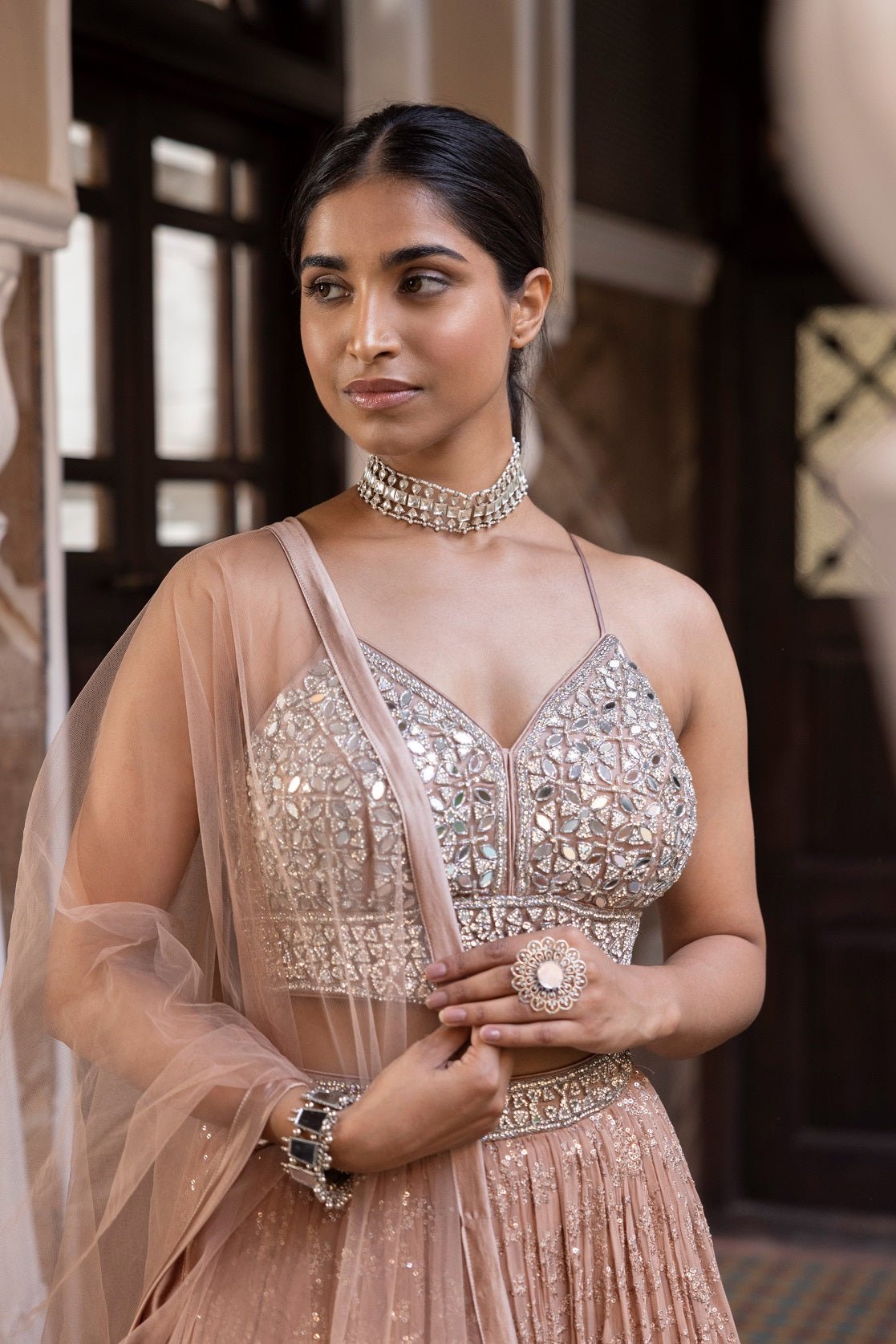 Shop beautiful rose gold mirror work georgette lehenga online in USA with dupatta. Dazzle on weddings and special occasions with exquisite Indian designer dresses, sharara suits, Anarkali suits, bridal lehengas, sharara suits from Pure Elegance Indian clothing store in USA.-front
