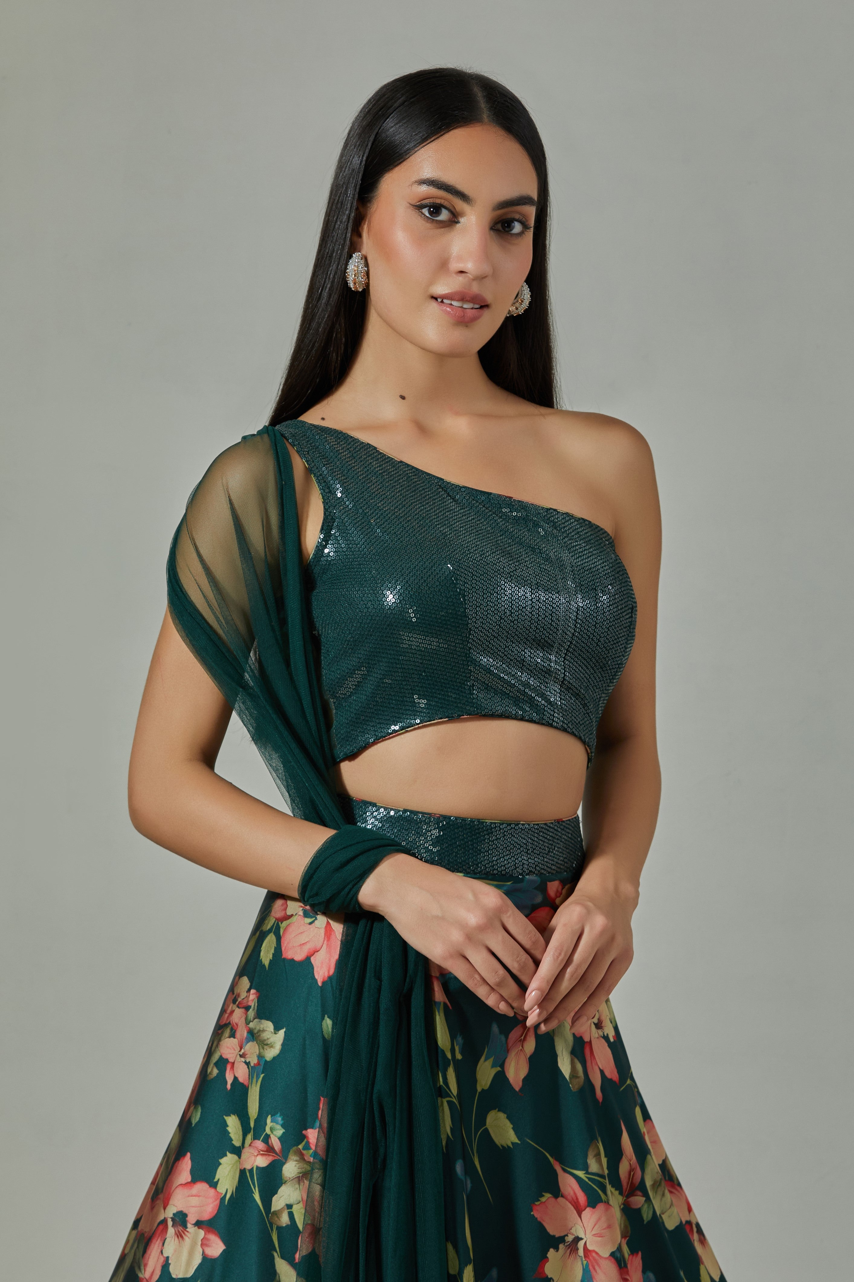 Shop beautiful teal printed satin lehenga online in USA with sequin blouse. Dazzle on weddings and special occasions with exquisite Indian designer dresses, sharara suits, Anarkali suits, wedding lehengas from Pure Elegance Indian fashion store in USA.-closeup